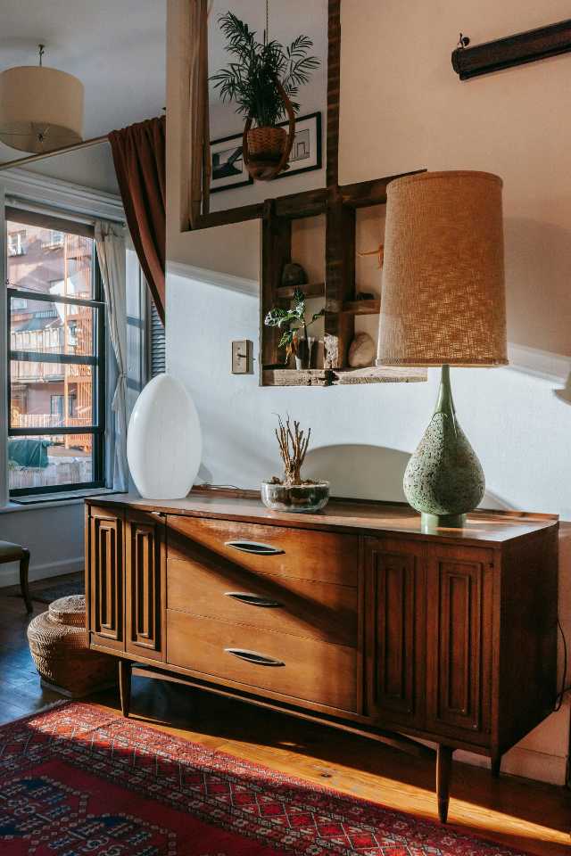 thai inspired design with hand crafted wood cabinet, green lamp and red area rug